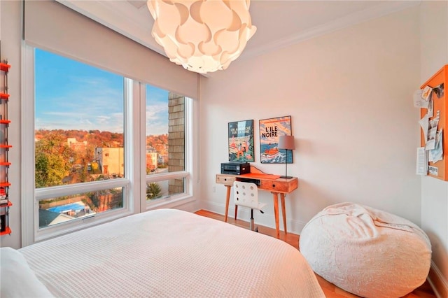 11 River St Unit 401, Sleepy Hollow, NY 10591 - bedroom with a chandelier, baseboards, wood finished floors, and crown molding