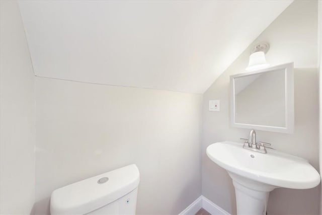 bathroom featuring toilet and vaulted ceiling