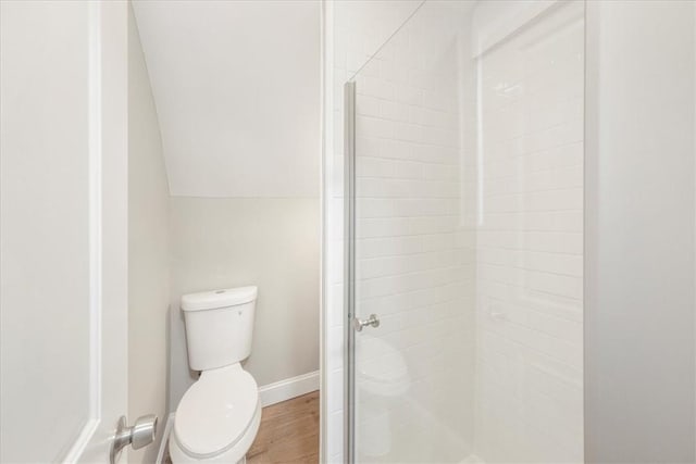 bathroom with wood-type flooring, toilet, an enclosed shower, and lofted ceiling