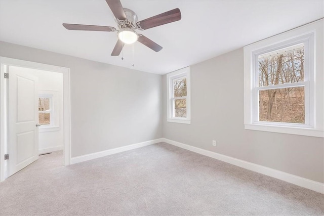 empty room with light colored carpet and ceiling fan