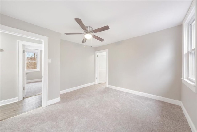 carpeted empty room featuring ceiling fan