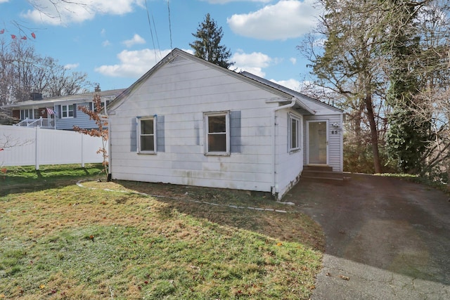 view of side of property with a yard