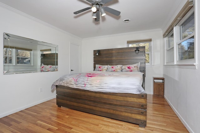 bedroom with ceiling fan, light hardwood / wood-style floors, and ornamental molding