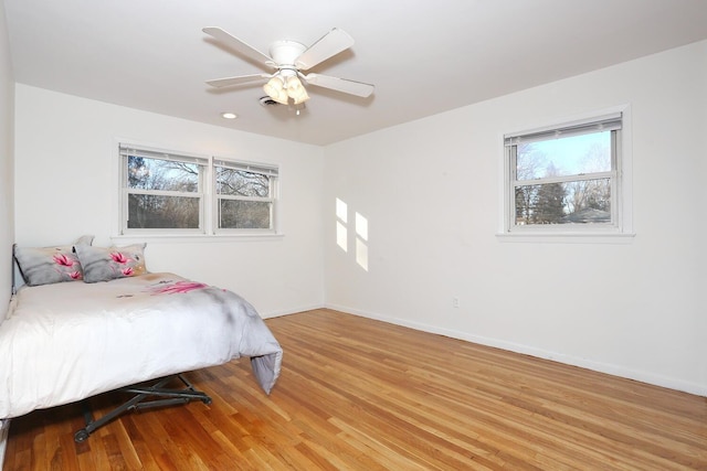 bedroom with ceiling fan and light hardwood / wood-style flooring