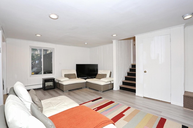 living room featuring light wood-type flooring and a baseboard heating unit