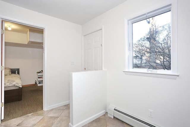 interior space featuring a wealth of natural light and baseboard heating