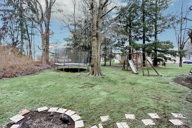 view of yard with a playground and a trampoline