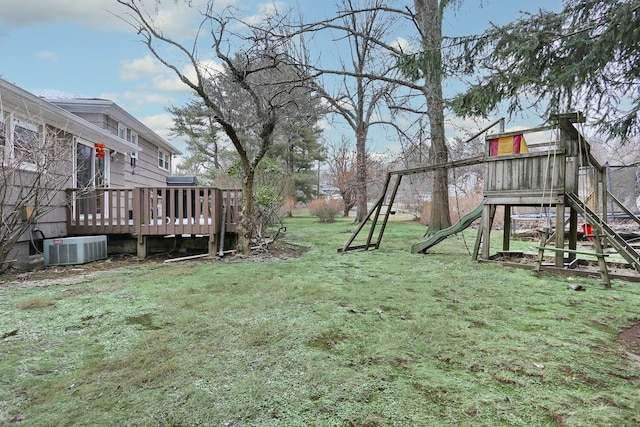 view of yard with a playground, central AC, and a wooden deck