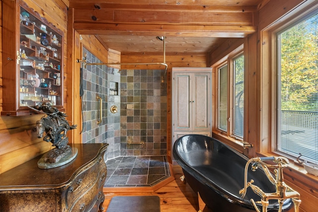 bathroom with separate shower and tub, wooden walls, and hardwood / wood-style flooring