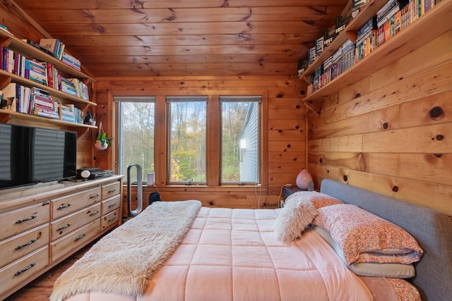 bedroom with vaulted ceiling, wood-type flooring, wooden walls, and wooden ceiling