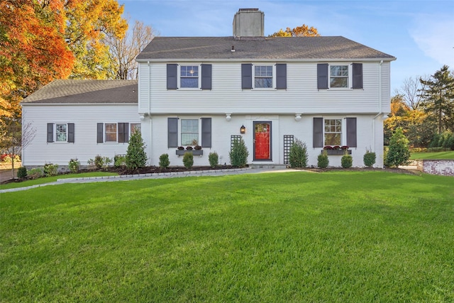 205 River Rd, Briarcliff Manor, NY 10510 - colonial home with a chimney, a front yard, a shingled roof, and brick siding