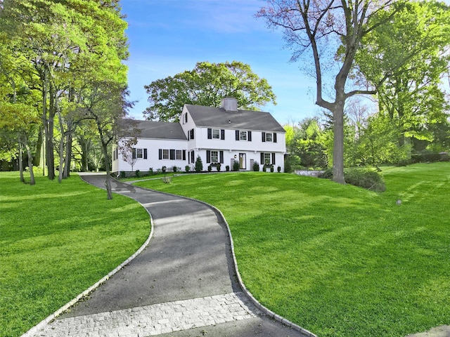 205 River Rd, Briarcliff Manor, NY 10510 - colonial inspired home featuring a chimney, a front lawn, and driveway