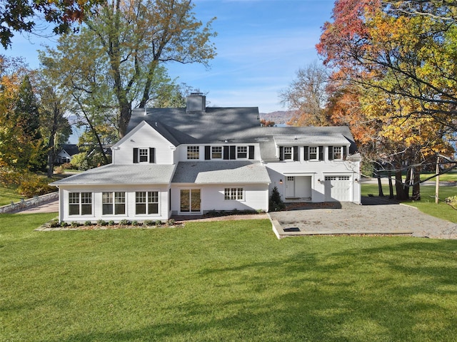 205 River Rd, Briarcliff Manor, NY 10510 - rear view of house with a garage, a chimney, a lawn, roof with shingles, and driveway