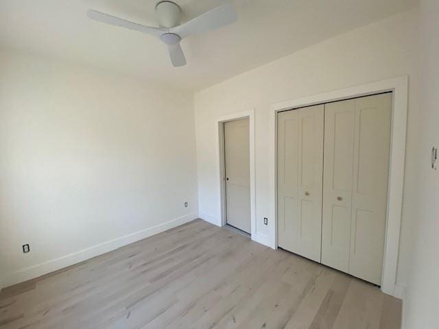 unfurnished bedroom featuring ceiling fan, a closet, and light hardwood / wood-style flooring