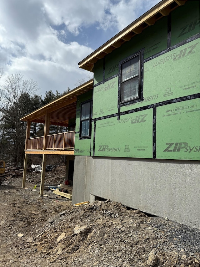 view of property exterior with a deck