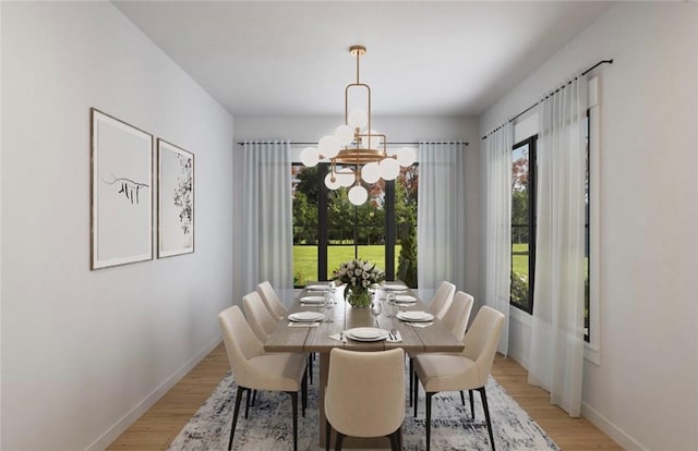 dining space with a chandelier, baseboards, and light wood finished floors