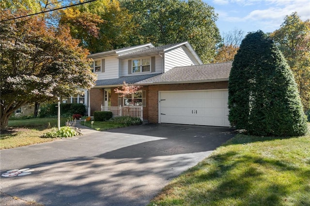 view of front of property with a porch and a garage