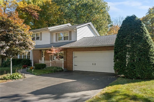 view of front of house featuring a porch and a garage