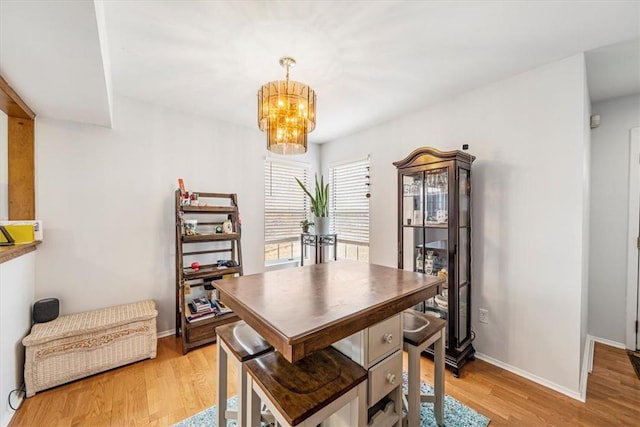 dining area with a notable chandelier and light wood-type flooring