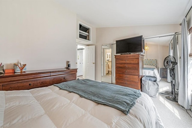 bedroom featuring carpet, a closet, and lofted ceiling