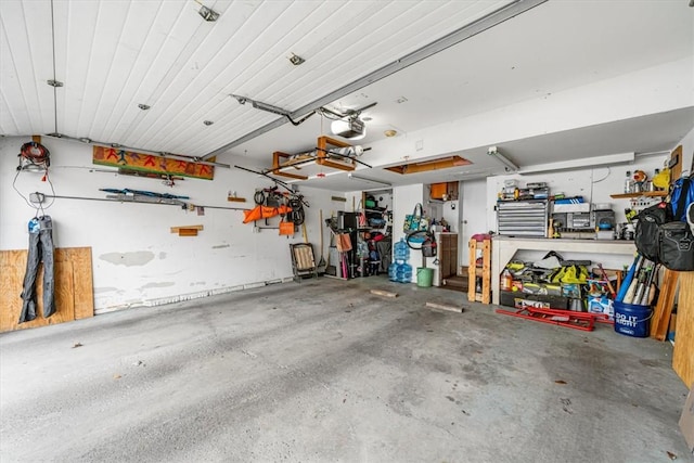 garage with a workshop area and a garage door opener