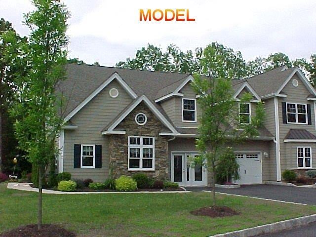 craftsman-style house with french doors, a garage, and a front lawn