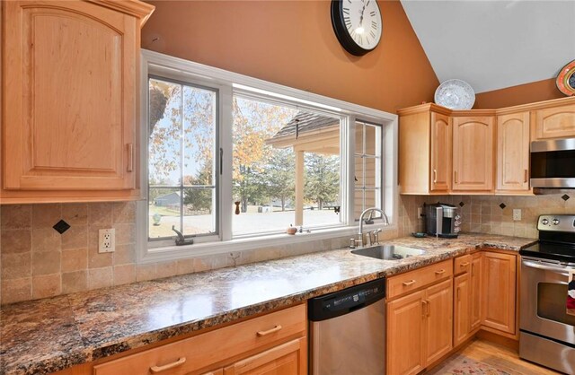 339 Jessup Rd, Florida, NY 10921 - kitchen with stainless steel appliances, light brown cabinetry, lofted ceiling, dark stone countertops, and decorative backsplash