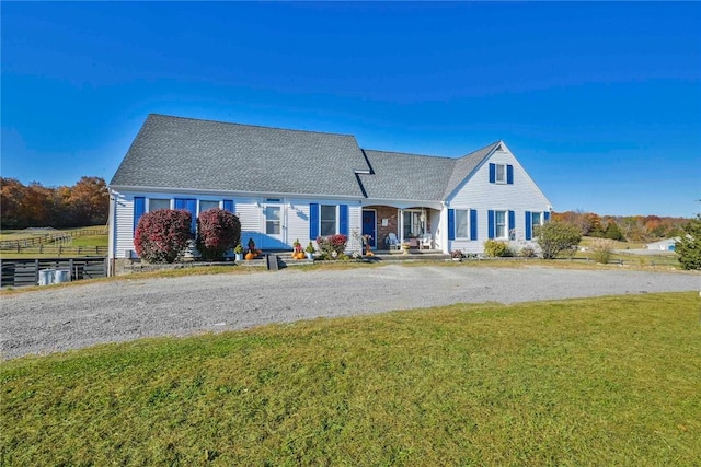 cape cod house featuring a front lawn