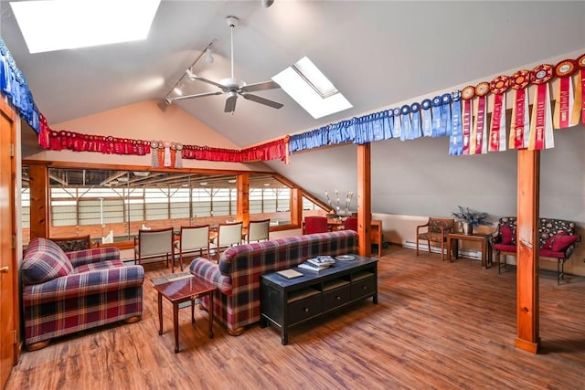 bedroom with hardwood / wood-style floors, rail lighting, and vaulted ceiling