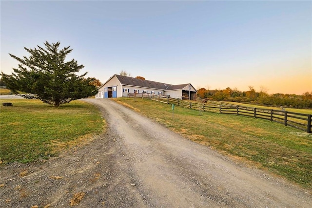 view of front of home featuring a rural view and a lawn