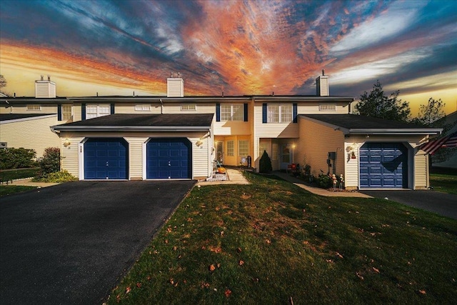 view of front facade with a garage and a lawn