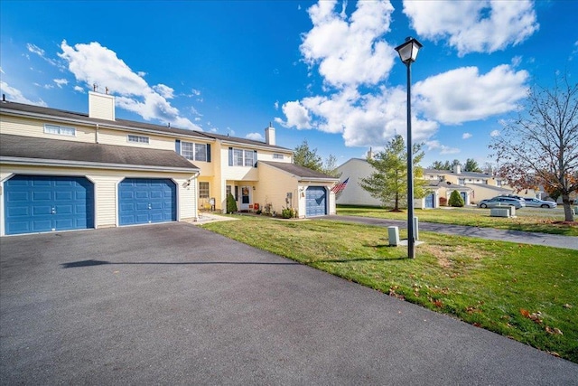 view of front of house with a front yard and a garage