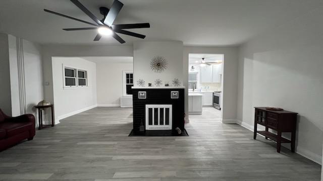 kitchen with hardwood / wood-style flooring, ceiling fan, and range