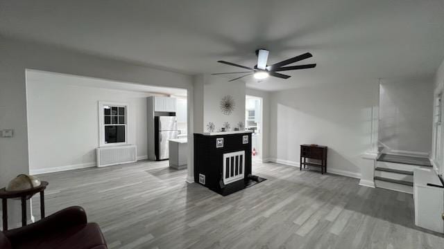 living room featuring hardwood / wood-style flooring and ceiling fan