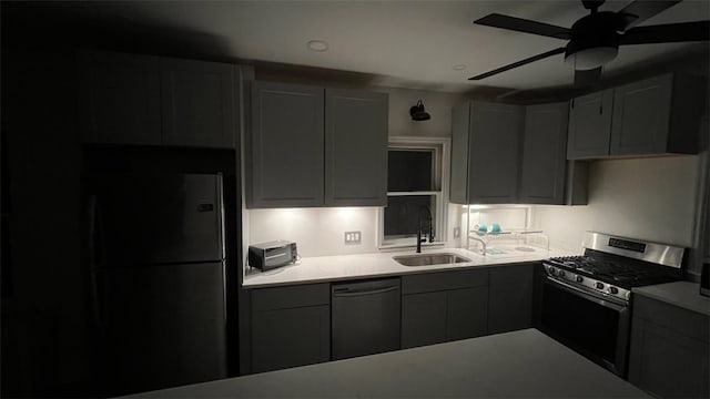 kitchen with gray cabinetry, ceiling fan, sink, and black appliances