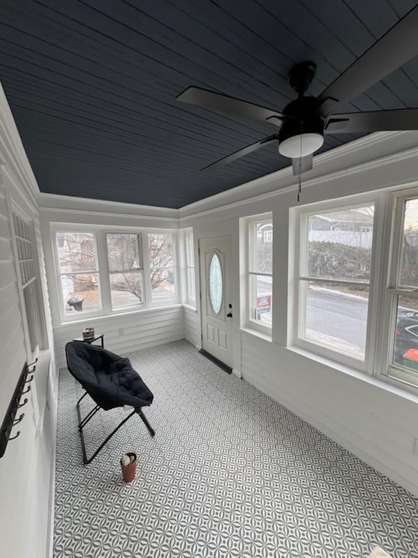 sunroom with ceiling fan and wooden ceiling