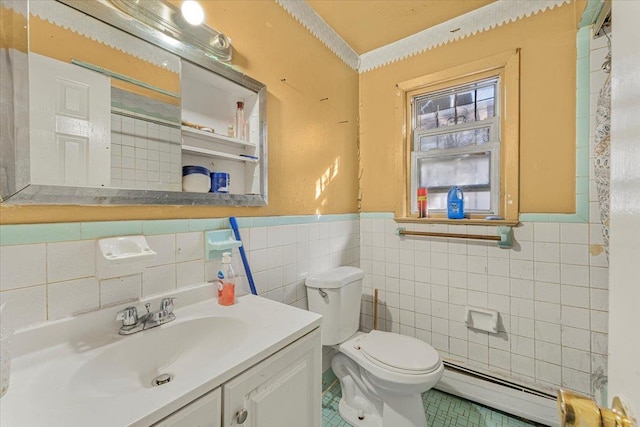 bathroom featuring vanity, toilet, tile walls, and a baseboard heating unit