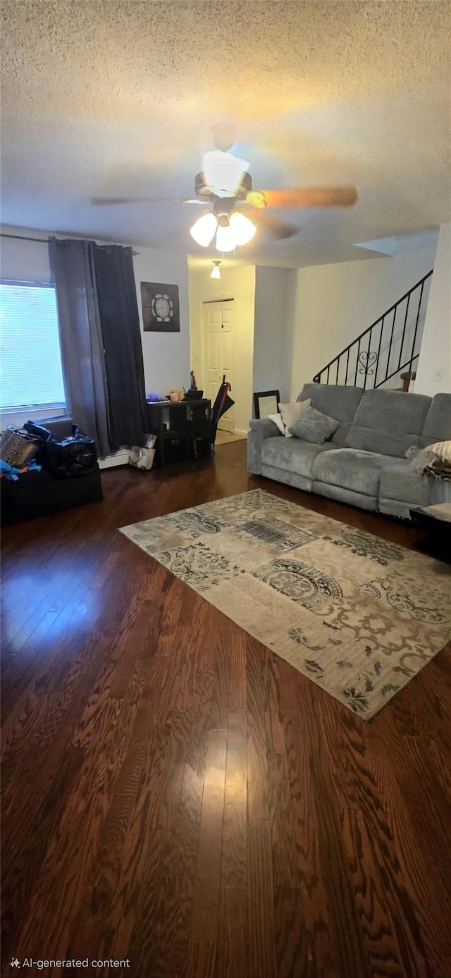 living room featuring ceiling fan, dark hardwood / wood-style floors, and a textured ceiling