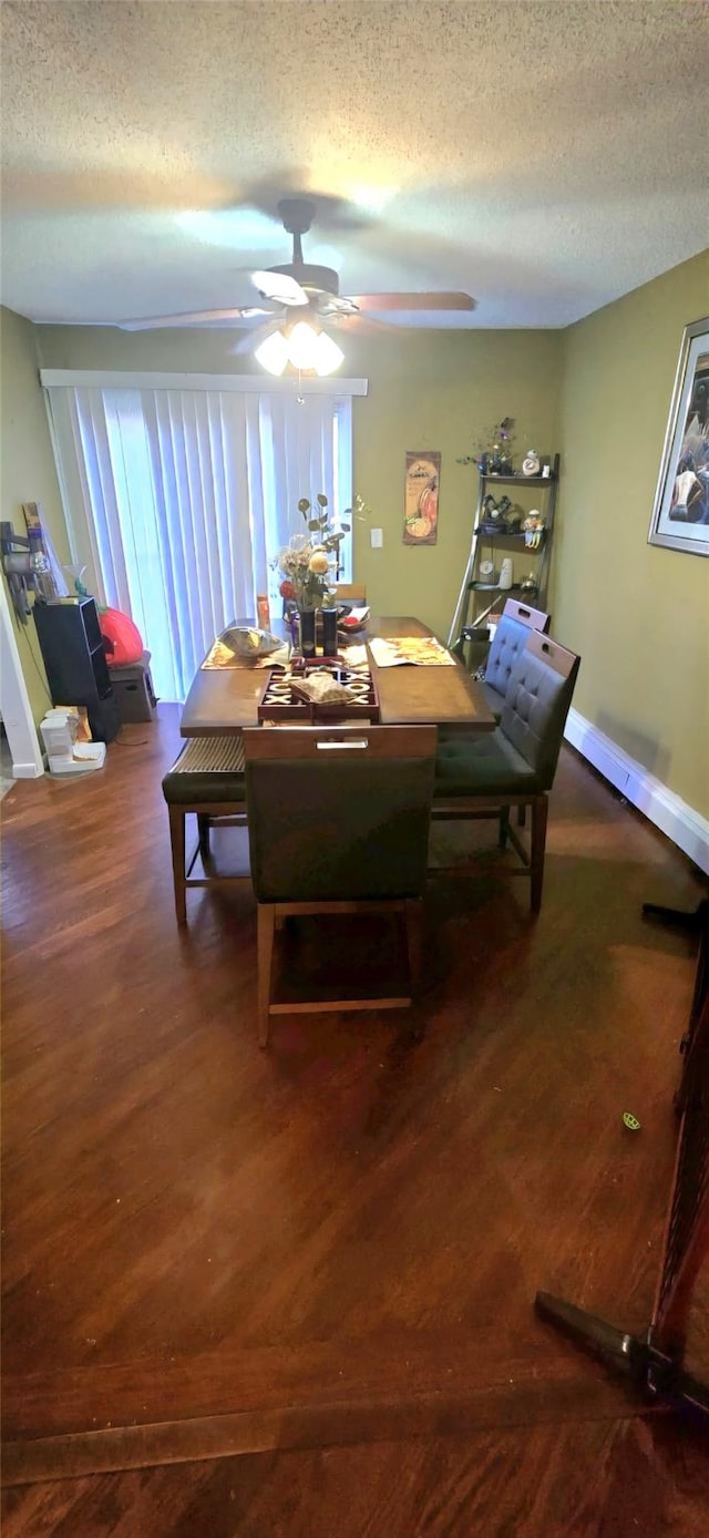 dining space with dark wood-type flooring, ceiling fan, and a textured ceiling