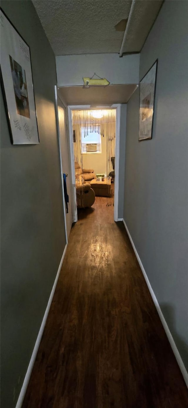 hall featuring hardwood / wood-style floors and a textured ceiling