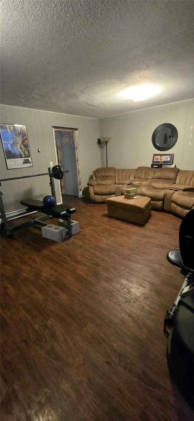 living room featuring dark hardwood / wood-style floors and a textured ceiling