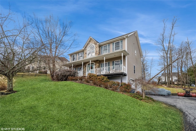 view of front of property featuring a porch and a front lawn