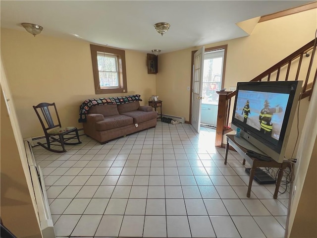 living room featuring light tile patterned floors and a baseboard radiator