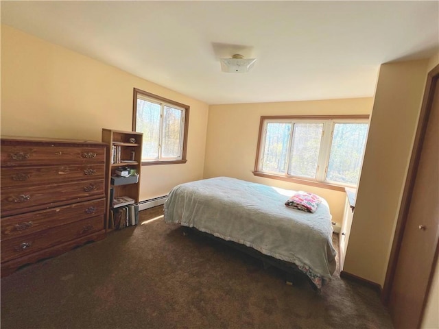 carpeted bedroom featuring baseboard heating