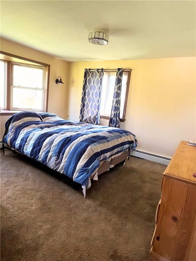 bedroom with dark carpet and a baseboard heating unit