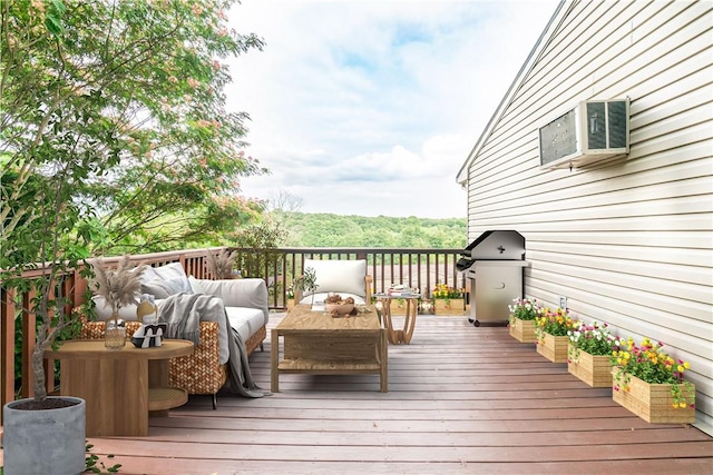 wooden terrace featuring outdoor lounge area, an AC wall unit, and area for grilling