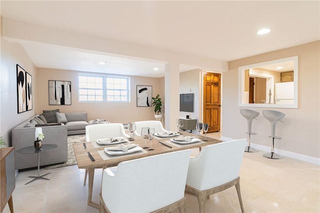 dining space featuring baseboards and recessed lighting