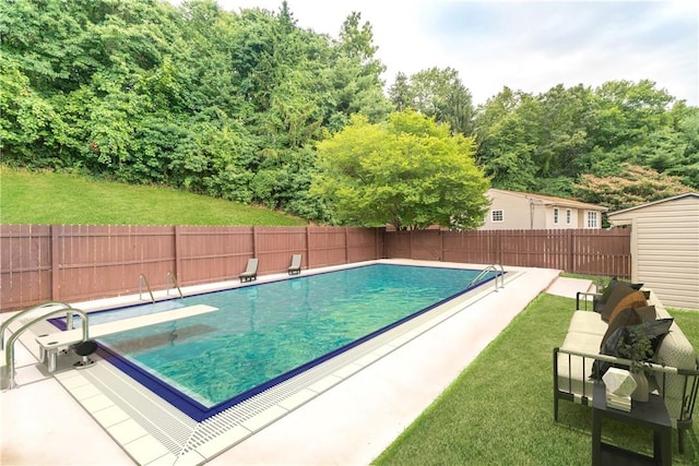 view of swimming pool featuring a fenced backyard, a diving board, a fenced in pool, and a yard