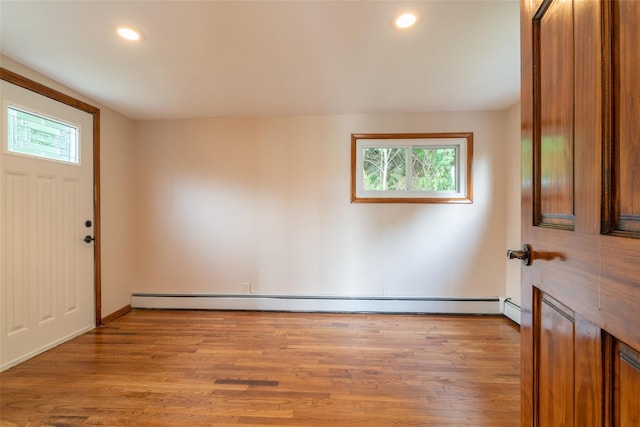 foyer with light wood-style flooring, baseboard heating, and recessed lighting