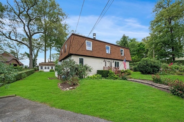 rear view of house featuring a lawn